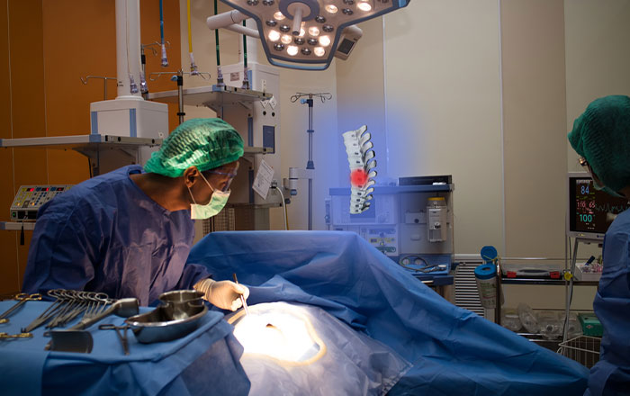 Doctor uses augmented reality to show the patient's spinal injury during surgery in the hospital operating room