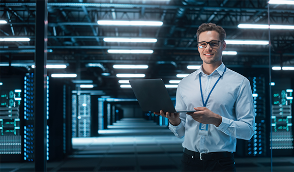 Managed NOC Services You Can Rely On Hand on keyboard with patient icons and health data above, symbolizing Managed NOC Services You Can Rely On